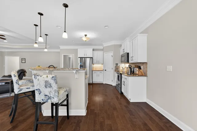 a view of kitchen and dining room with wooden floor