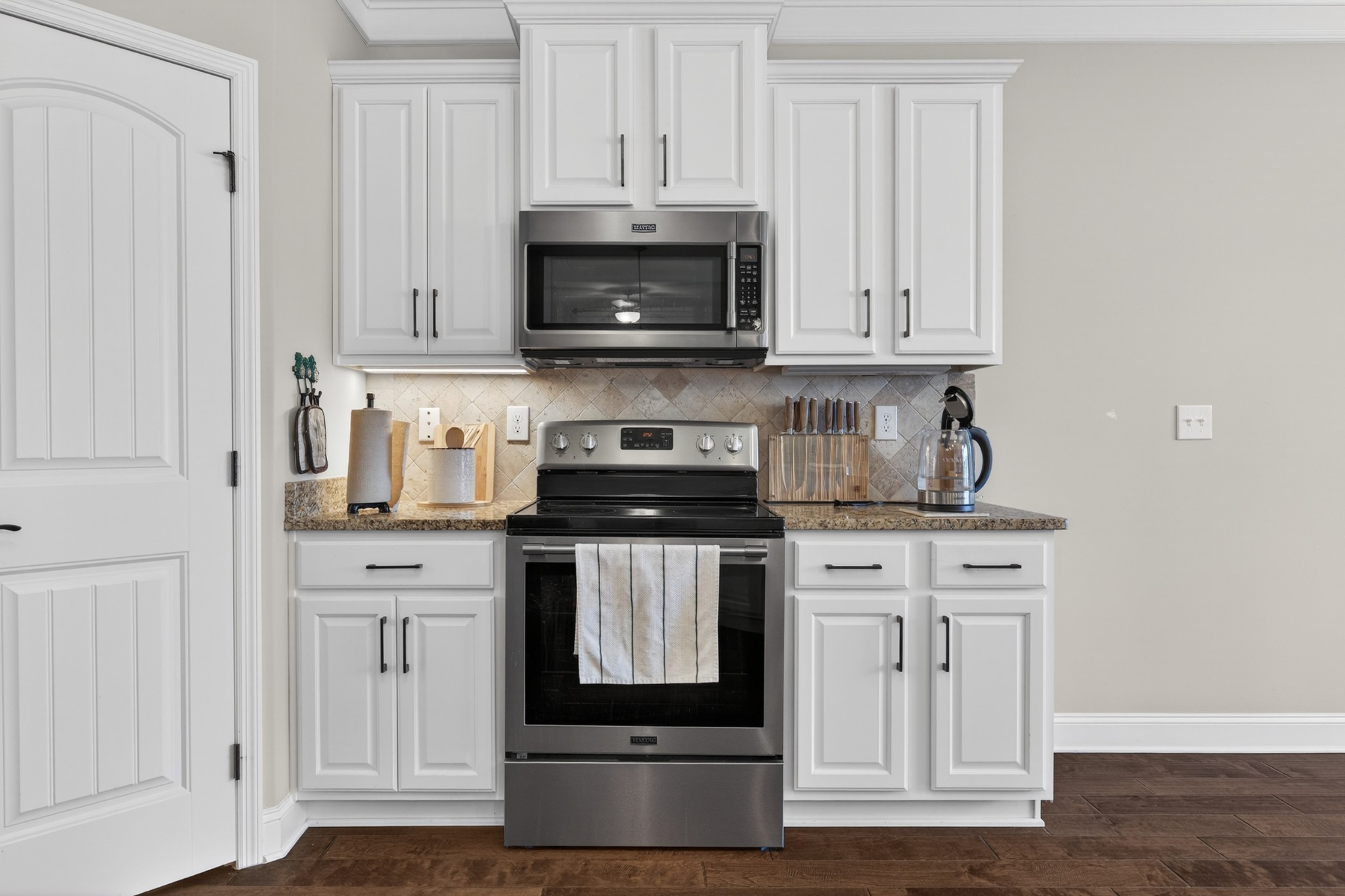 25 Knotting Hill Road Fayetteville, TN 37334 - Photo 19 of 49 a kitchen with stainless steel appliances granite countertop a stove a microwave and a white cabinets