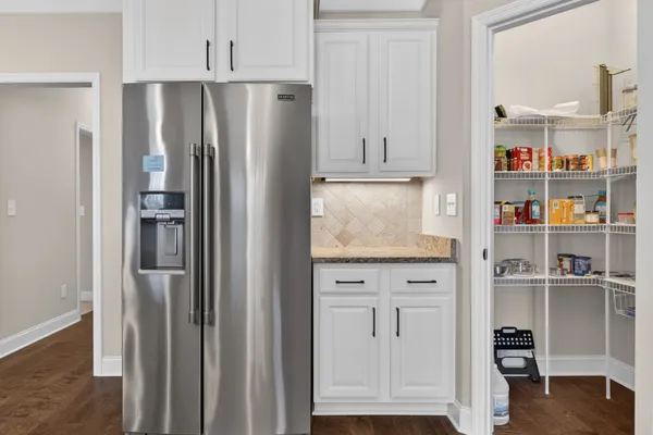 a kitchen with stainless steel appliances cabinets and a refrigerator