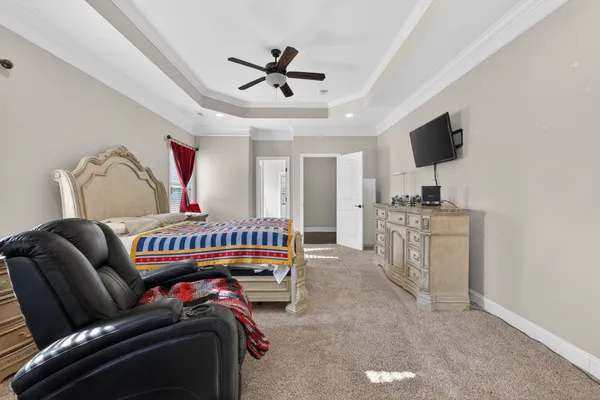 a bedroom with furniture and a flat screen tv