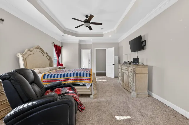 a bedroom with furniture and a flat screen tv