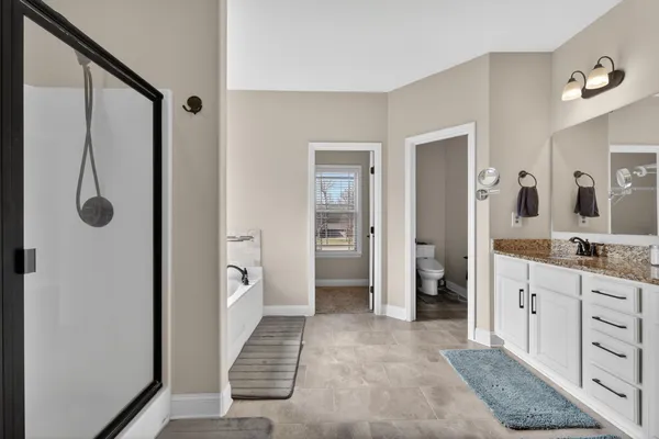 a spacious bathroom with a shower and a sink