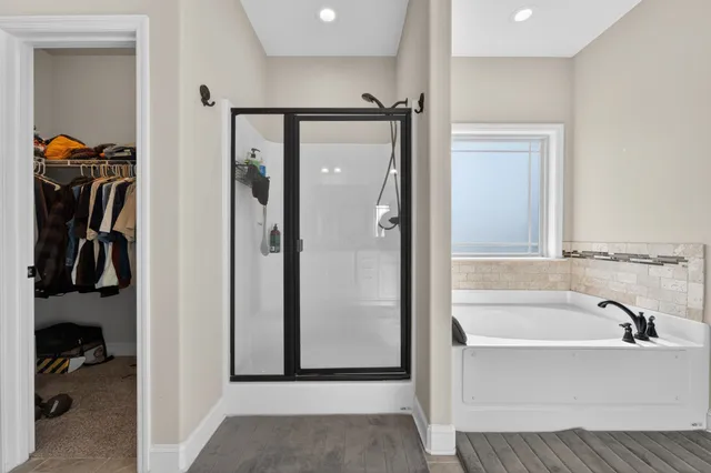 a bathroom with a bathtub and a shower
