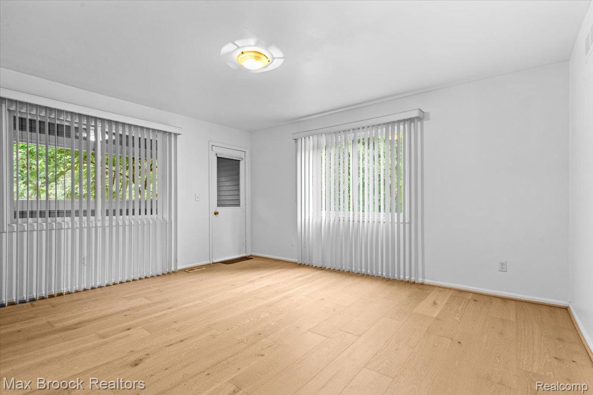 1830 Lone Pine Road Bloomfield Hills, MI 48302 - Photo 41 of 70 Smooth wood-finish flooring, white walls, and a ceiling-mounted light fixture with private enclosed balcony.