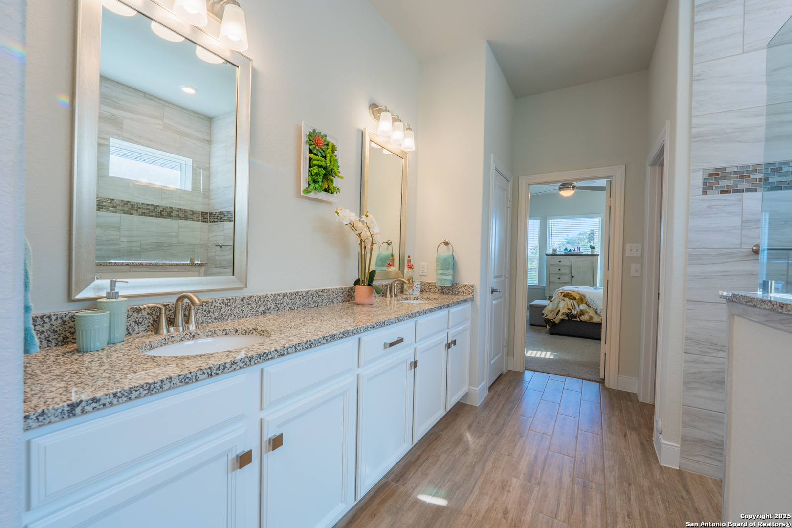 22842 Rio Salado San Antonio, TX 78261 - Photo 24 of 41 a bathroom with a granite countertop sink mirror and view