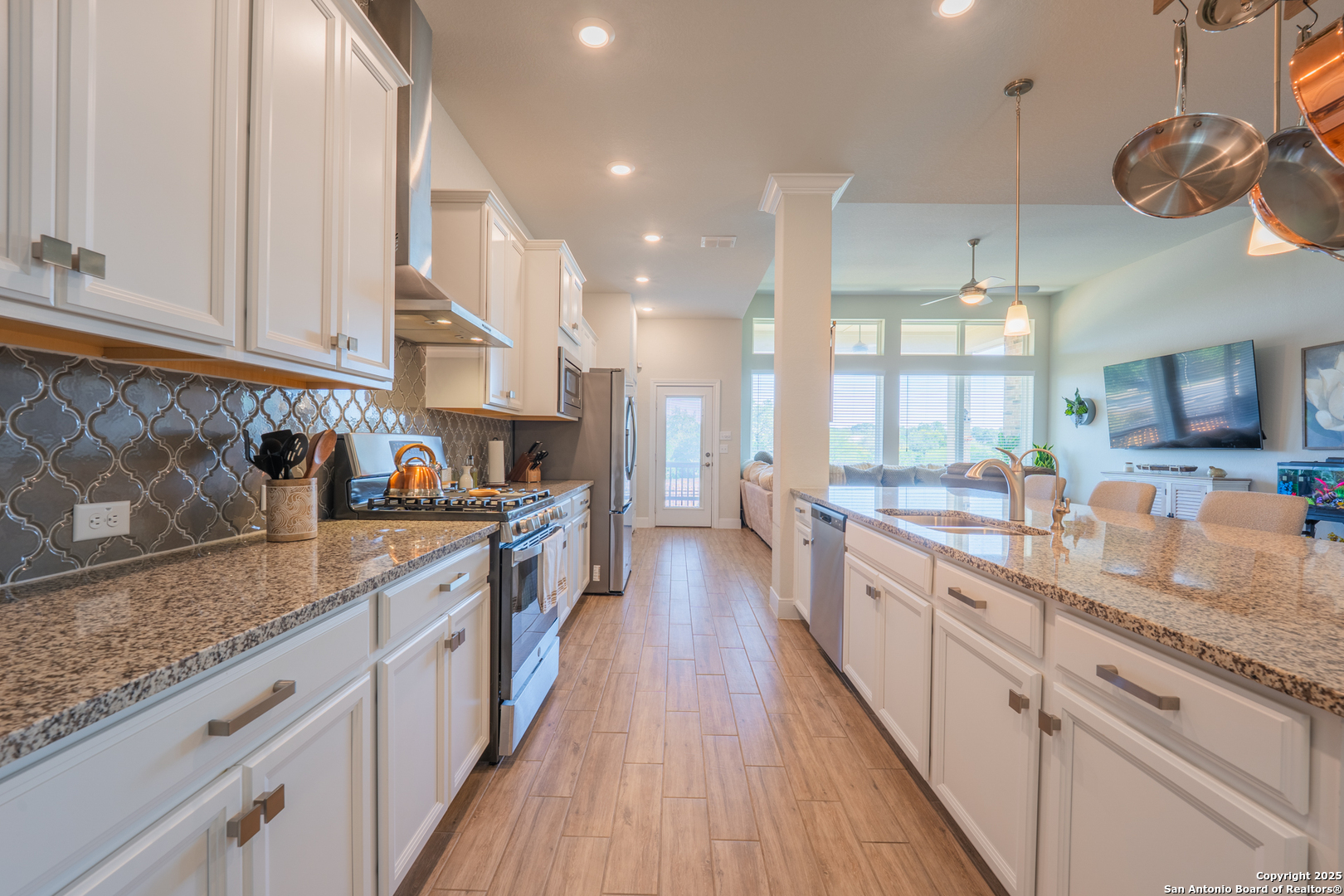 22842 Rio Salado San Antonio, TX 78261 - Photo 8 of 41 a large kitchen with stainless steel appliances granite countertop a lot of counter space and wooden floor