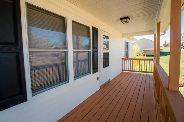 a view of front door deck and wooden floor