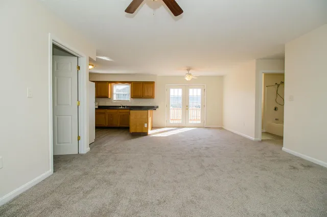 an empty room with a empty space and windows