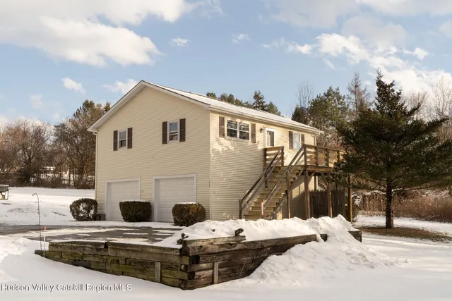 a view of a white house with a yard