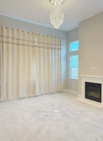 a view of staircase with lots of frames on wall and wooden floor