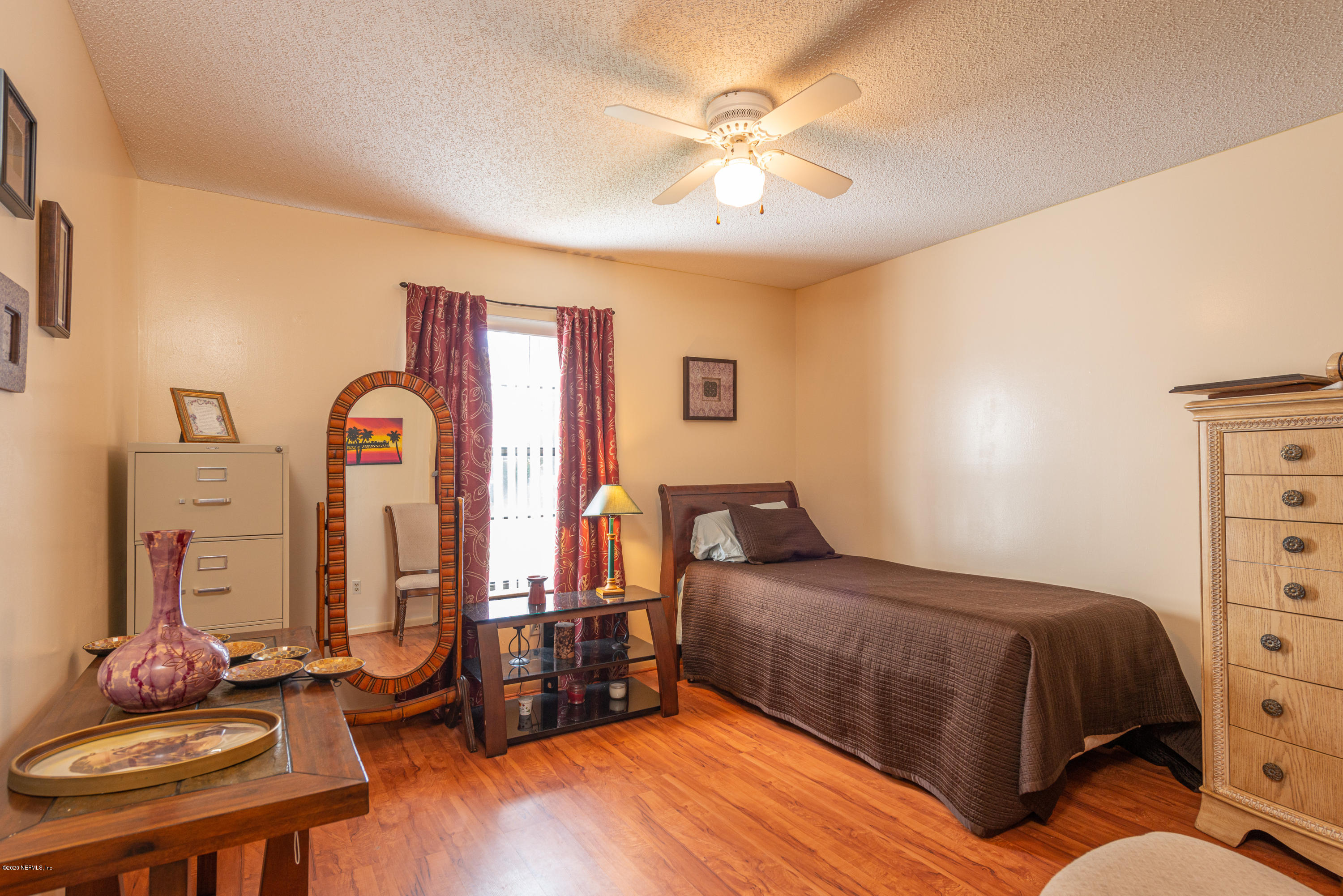 242 Jasmine Road St. Augustine, FL 32086 - Photo 14 of 26 a bedroom with a bed and wooden floor