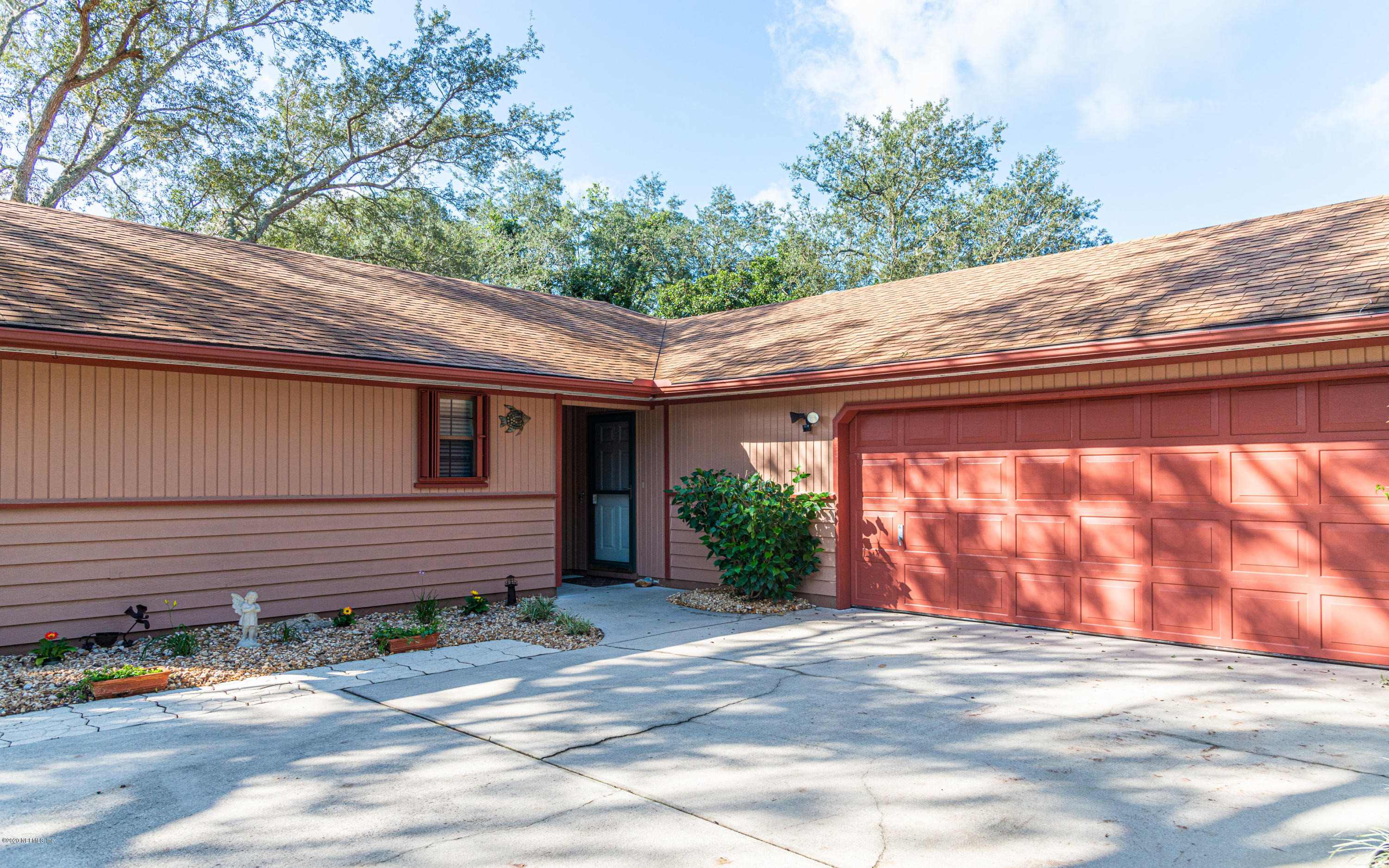242 Jasmine Road St. Augustine, FL 32086 - Photo 18 of 26 a front view of a house with a garden