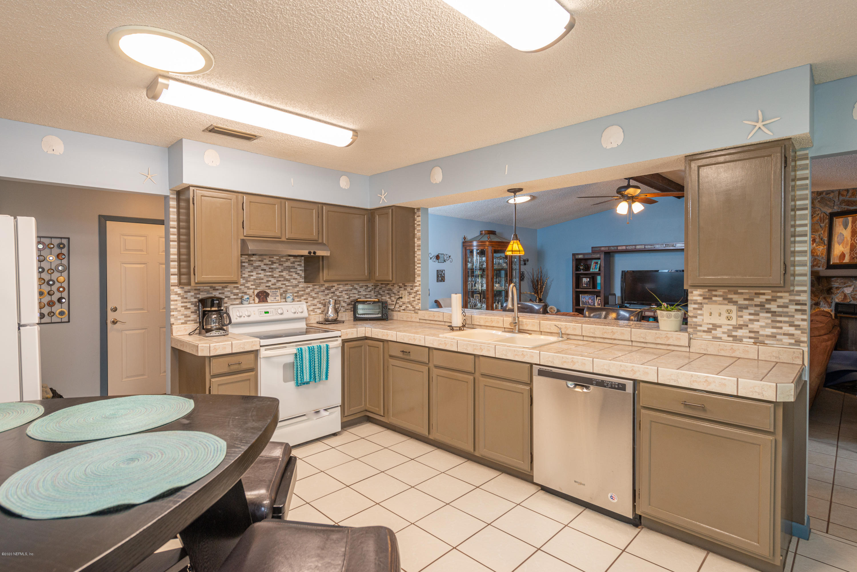 242 Jasmine Road St. Augustine, FL 32086 - Photo 2 of 26 a kitchen with white cabinets appliances and furniture