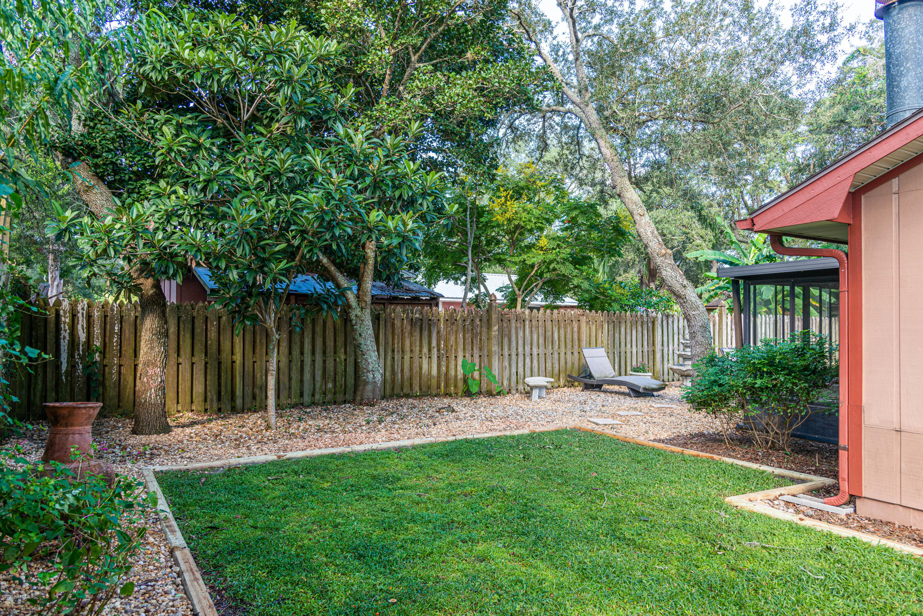 242 Jasmine Road St. Augustine, FL 32086 - Photo 24 of 26 a backyard of a house with table and chairs