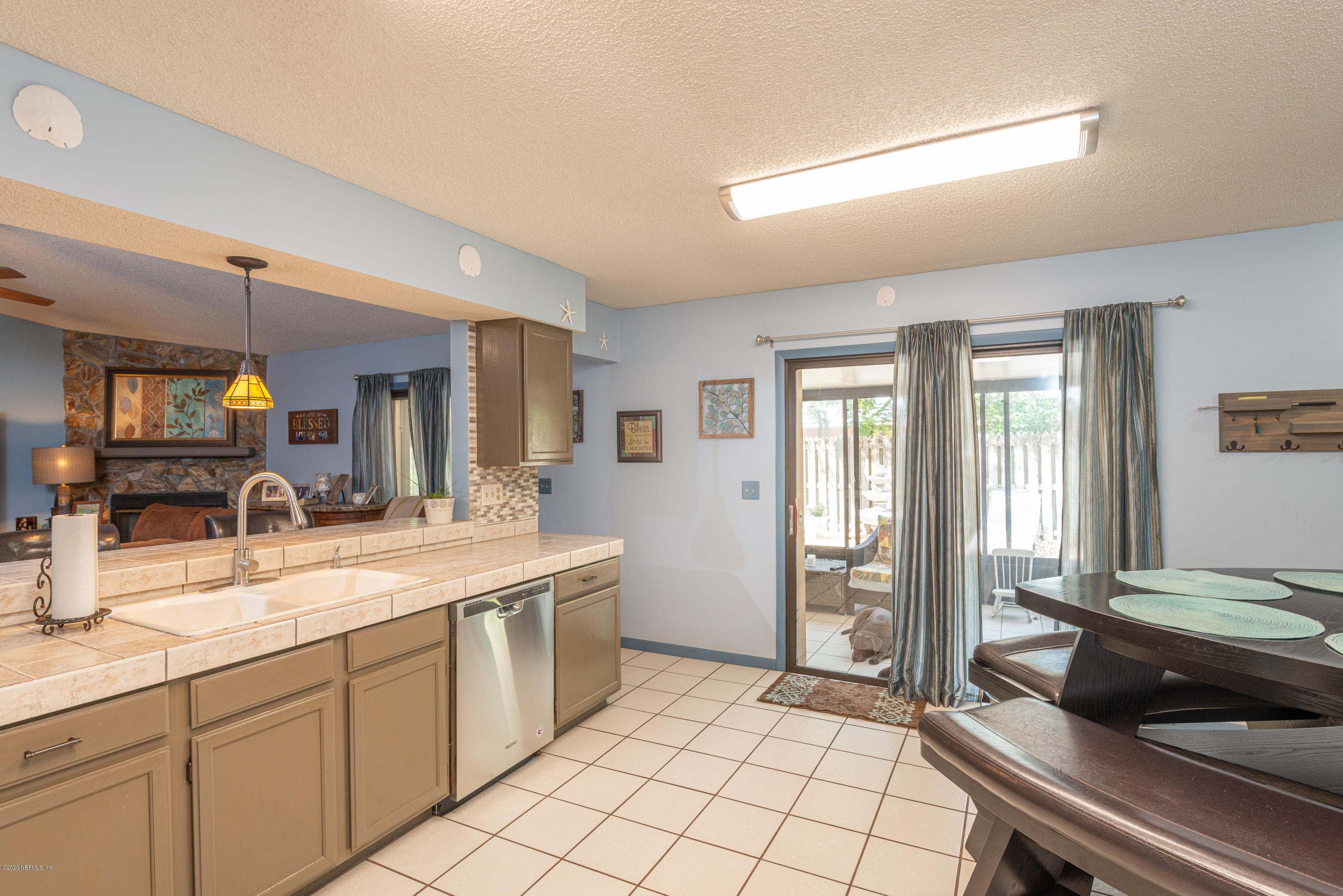 242 Jasmine Road St. Augustine, FL 32086 - Photo 3 of 26 a kitchen with a sink and a refrigerator