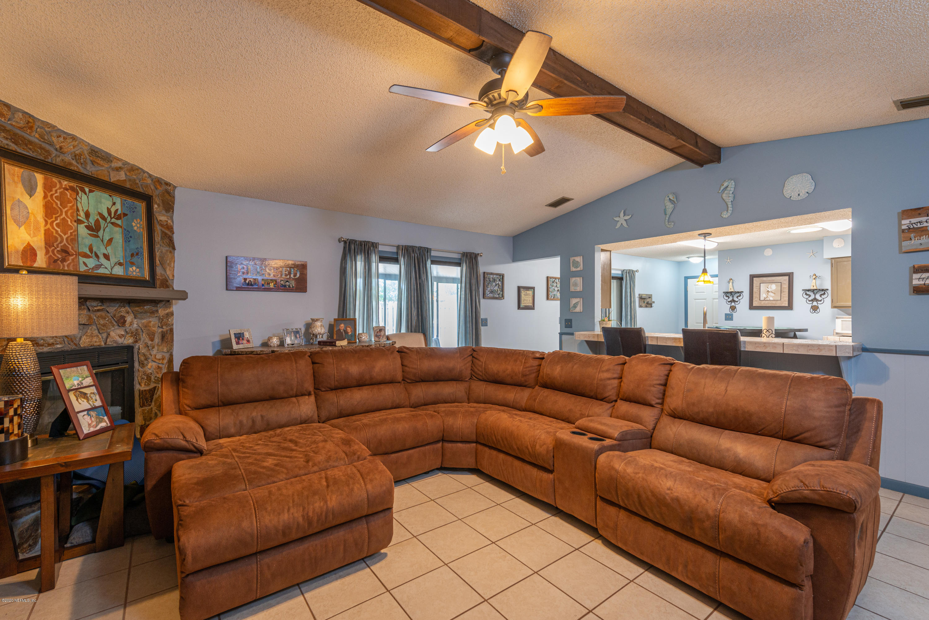 242 Jasmine Road St. Augustine, FL 32086 - Photo 7 of 26 a living room with furniture a fireplace and a flat screen tv