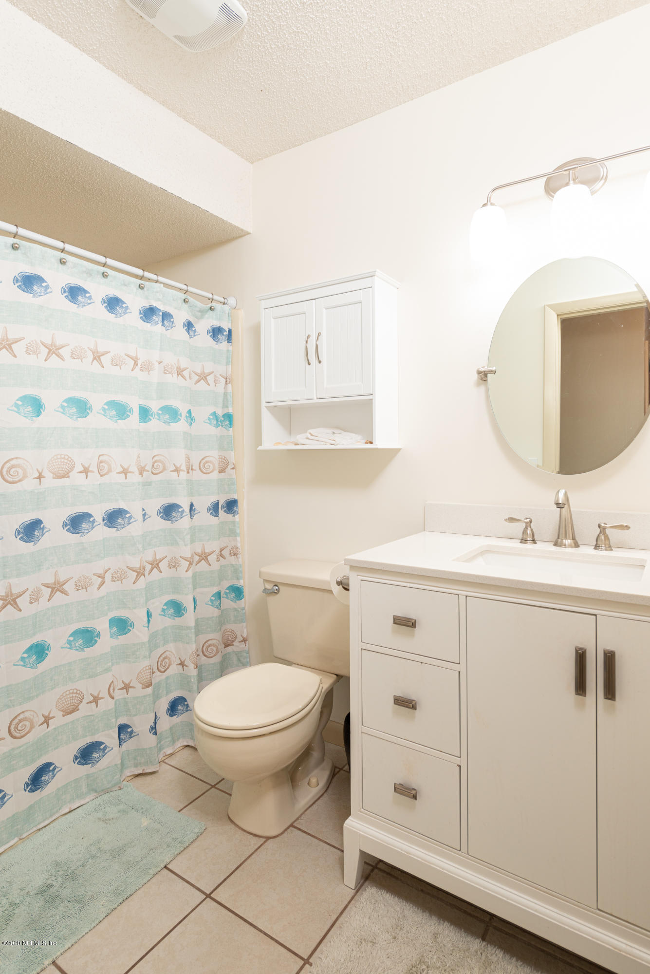 242 Jasmine Road St. Augustine, FL 32086 - Photo 10 of 26 a bathroom with a sink a toilet and shower curtain