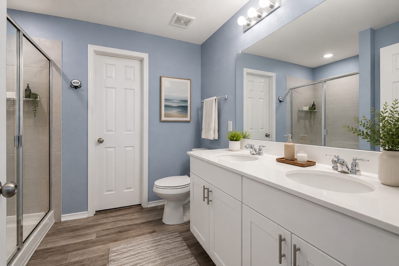 340 Harper Lane Georgetown, TX 78626 - Photo 17 of 28 Primary Bathroom featuring a dual-sink vanity with white cabinetry and chrome hardware, a full-width mirror, and a walk-in shower with a glass enclosure. Ai generated photo.