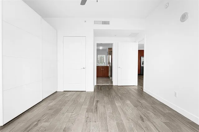 a view of an empty room with wooden floor