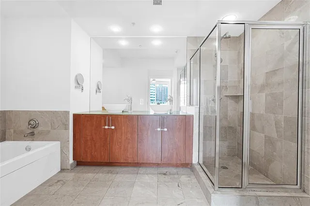 a kitchen with granite countertop a refrigerator and a sink