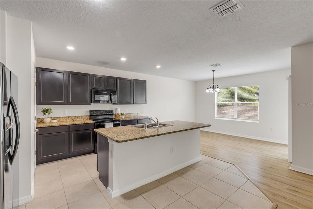 48 Hickory Loop Ocala, FL 34472 - Photo 13 of 52 a kitchen with stainless steel appliances granite countertop a stove and a sink