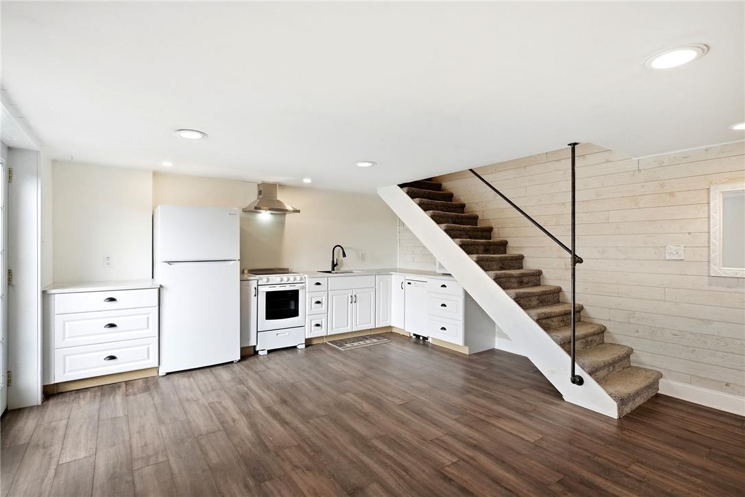 463 North Penn Dixie Road Bath, PA 18014 - Photo 36 of 86 A well-appointed kitchen with warm wood flooring anchors this versatile living space featuring a carpeted staircase.