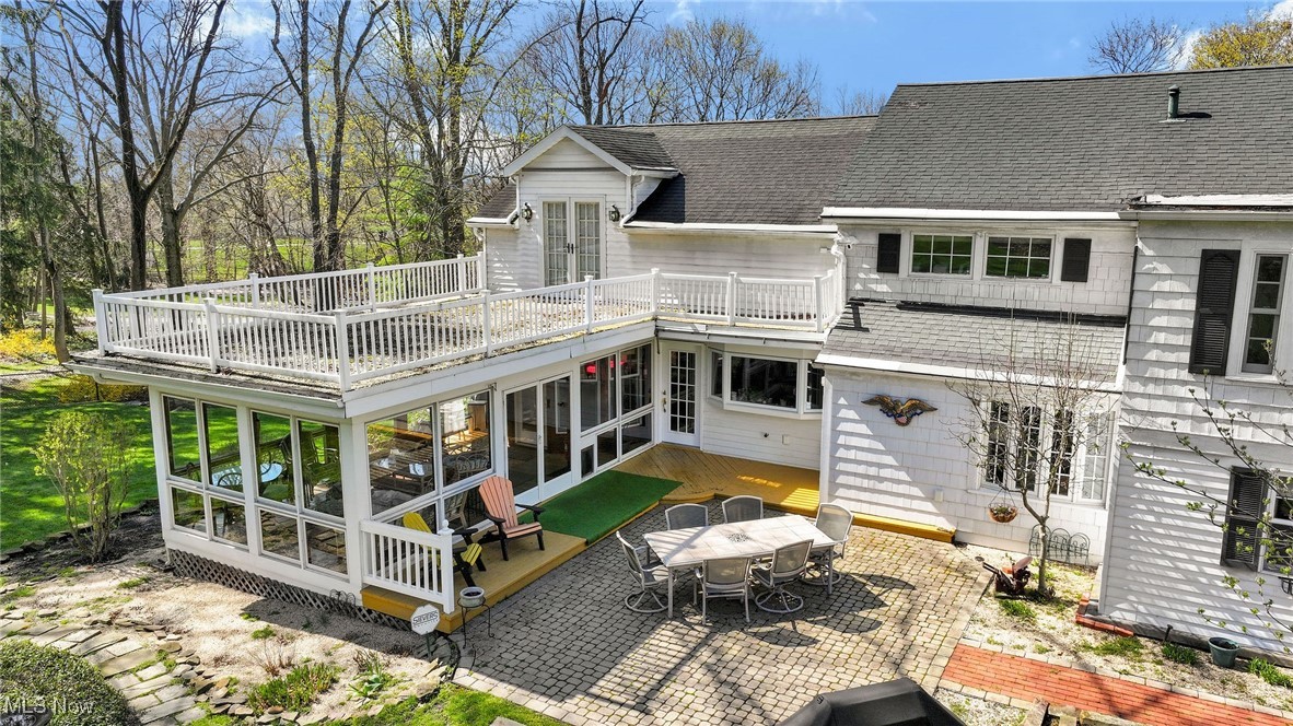 644 Riverside Drive Painesville, OH 44077 - Photo 30 of 48 Back of house featuring a wooden deck, a patio area, a shingled roof, and french doors