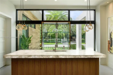 a bathroom with a granite countertop sink and large window