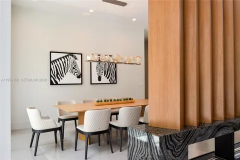 a kitchen with stainless steel appliances kitchen island granite countertop a table and chairs