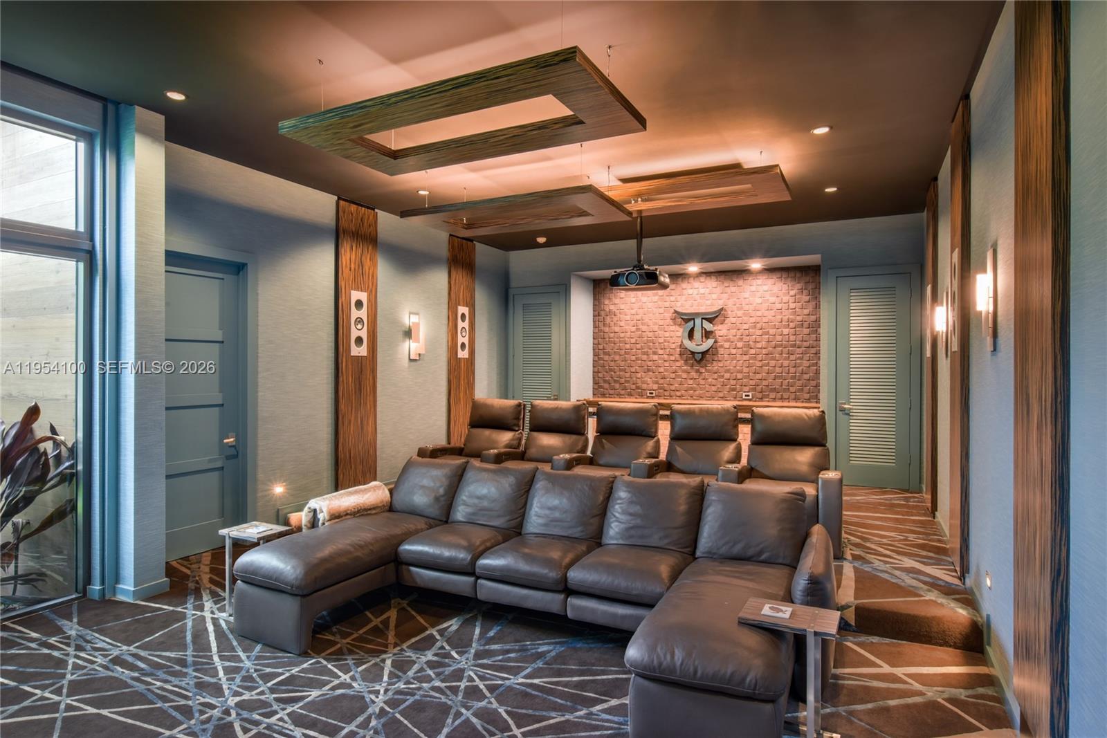 11050 Southwest 69th Avenue Pinecrest, FL 33156 - Photo 19 of 31 a media room with furniture a rug and a chandelier