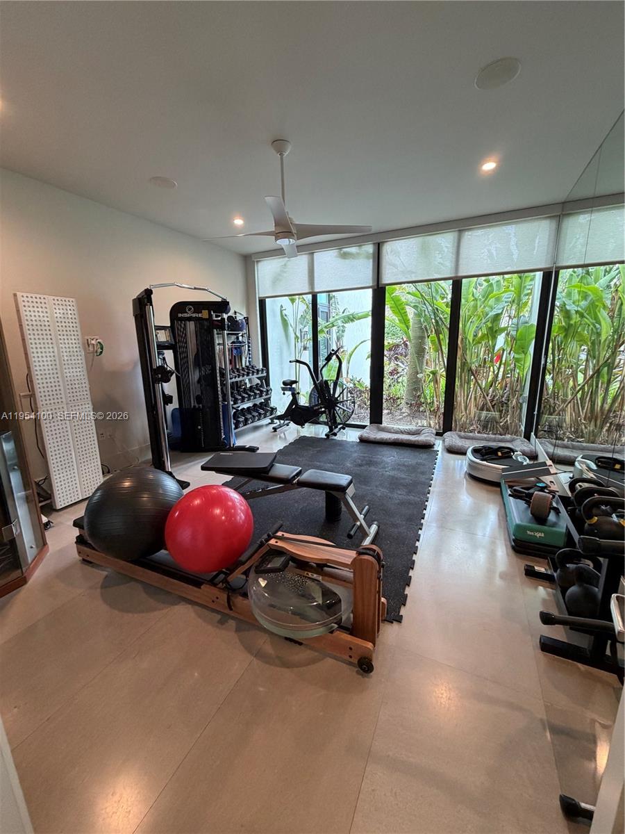 11050 Southwest 69th Avenue Pinecrest, FL 33156 - Photo 20 of 31 a room with gym equipment and a large window