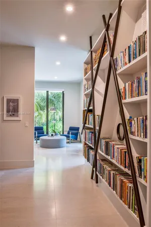 a bedroom with a bed couch and painting on the wall