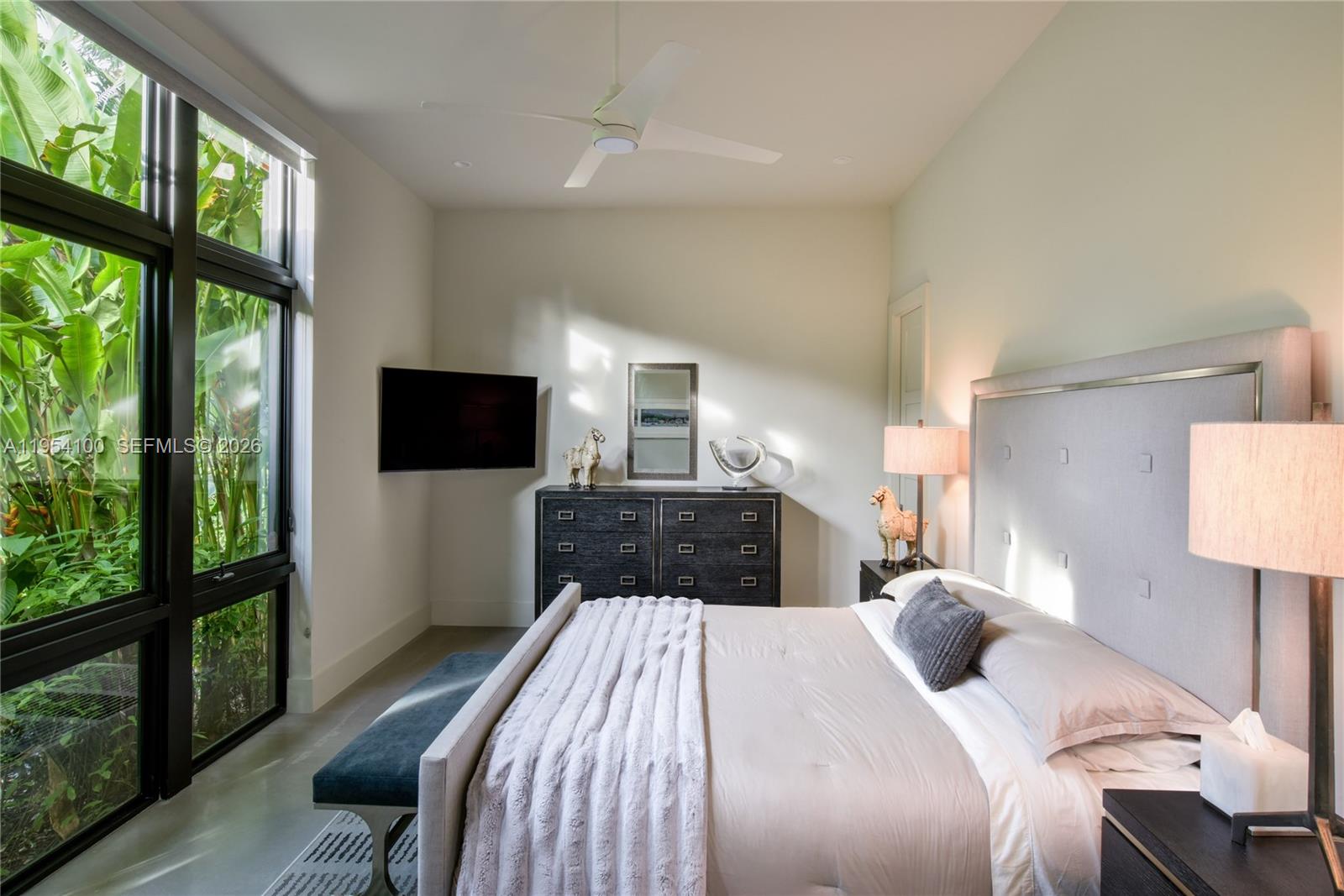 11050 Southwest 69th Avenue Pinecrest, FL 33156 - Photo 26 of 31 a bedroom with a bed and a flat screen tv