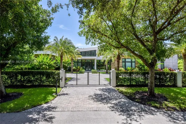 a view of a house with a backyard