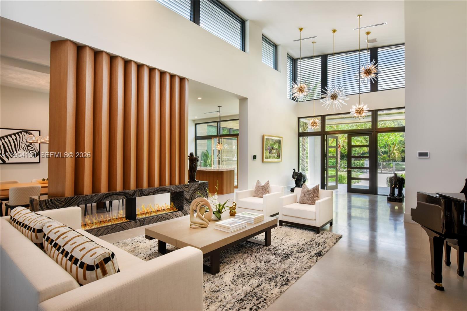 11050 Southwest 69th Avenue Pinecrest, FL 33156 - Photo 9 of 31 a living room with furniture and floor to ceiling windows