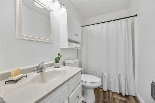 a bathroom with a sink a toilet and a mirror