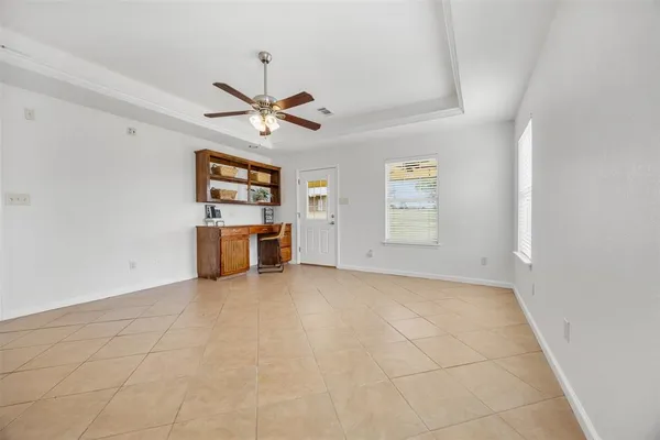 a view of a livingroom with a ceiling fan and window