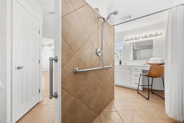 a bathroom with a shower and a sink