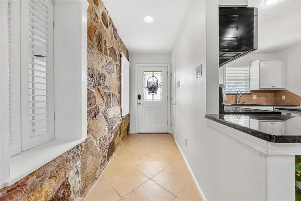 a hallway with a white stove and cabinets