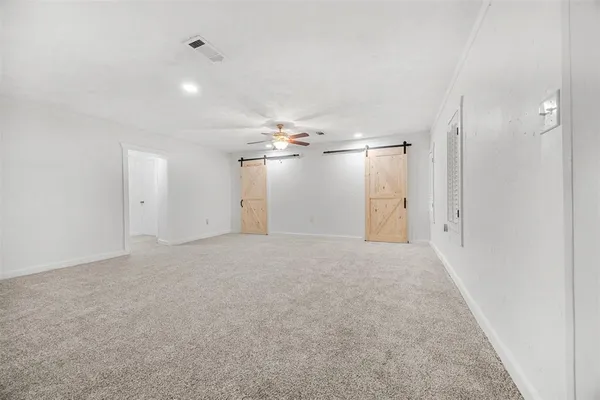 en empty room with an empty space and windows