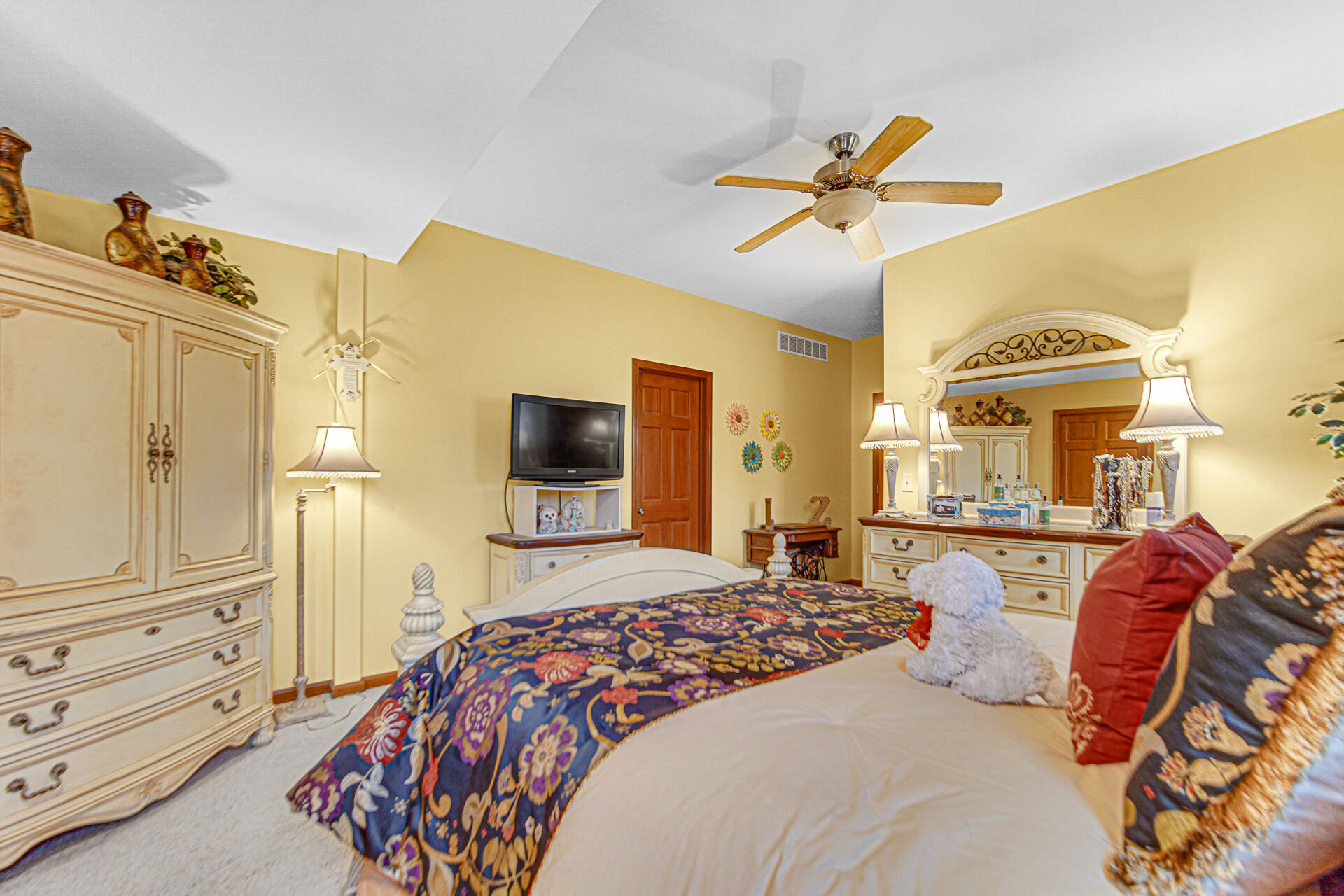 3252 Mockingbird Lane Valparaiso, IN 46383 - Photo 17 of 23 a bedroom with a bed and dresser with mirror
