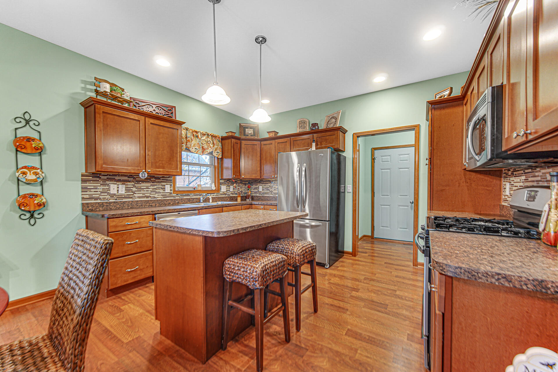 3252 Mockingbird Lane Valparaiso, IN 46383 - Photo 10 of 23 a large kitchen with stainless steel appliances granite countertop a stove a refrigerator a oven and a sink with granite countertops