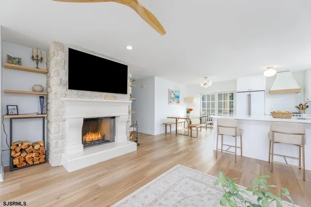 a living room with furniture a flat screen tv and a fireplace