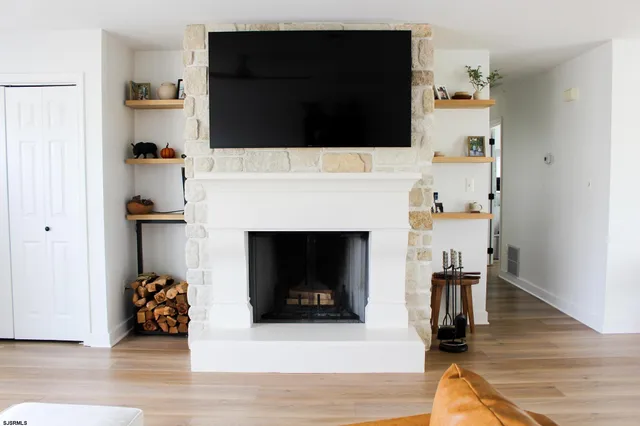 a living room with furniture and a fireplace
