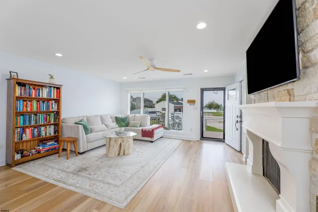 a living room with fireplace furniture and a flat screen tv