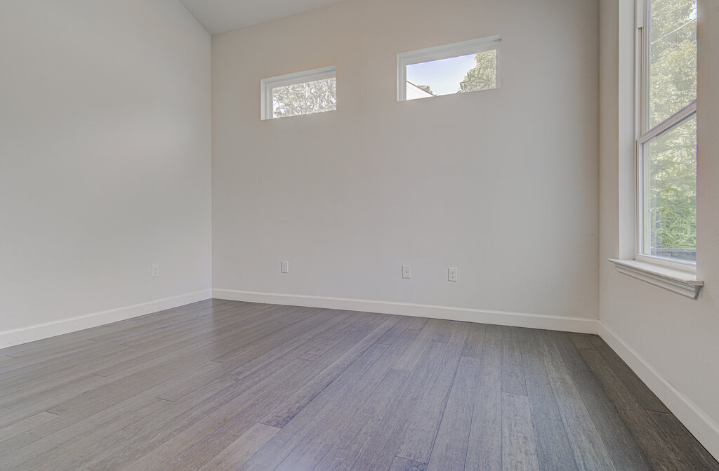 2406 East 16th Street Austin, TX 78702 - Photo 23 of 39 an empty room with wooden floor and windows