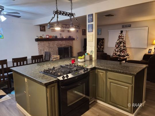 120 South Fire Opal Street Ridgecrest, CA 93555 - Photo 4 of 17 a stove top oven sitting inside of a kitchen