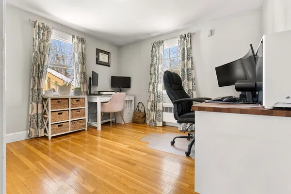 a view of a workspace with furniture and a flat screen tv