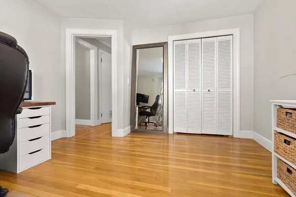 a view of a room with wooden floor and closet