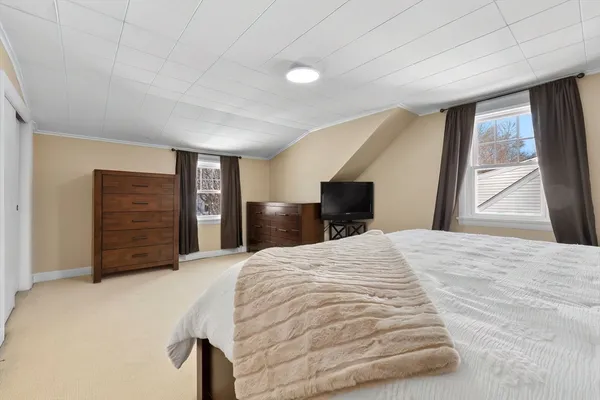a bedroom with a bed and a dresser
